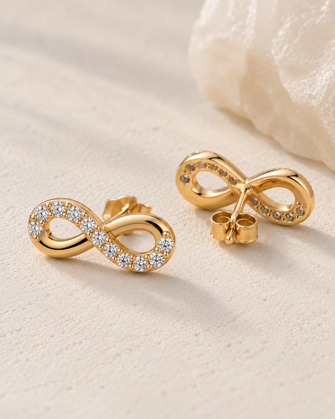 Close-up of Lab Grown Diamond Infinity Studs, showing the gold finish over sterling silver
