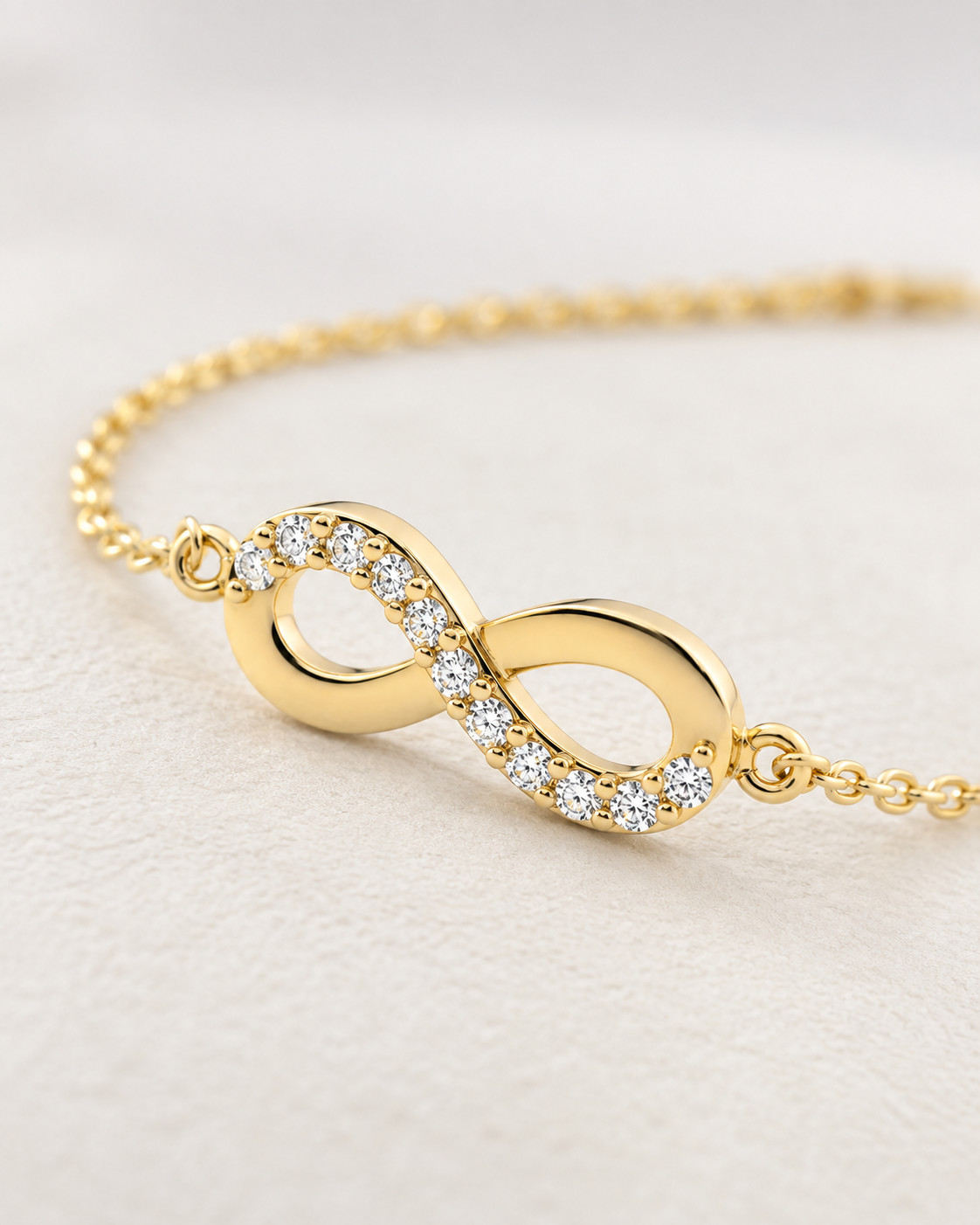 Close-up of Lab Grown Diamond Infinity Bracelet, showing the gold finish over sterling silver