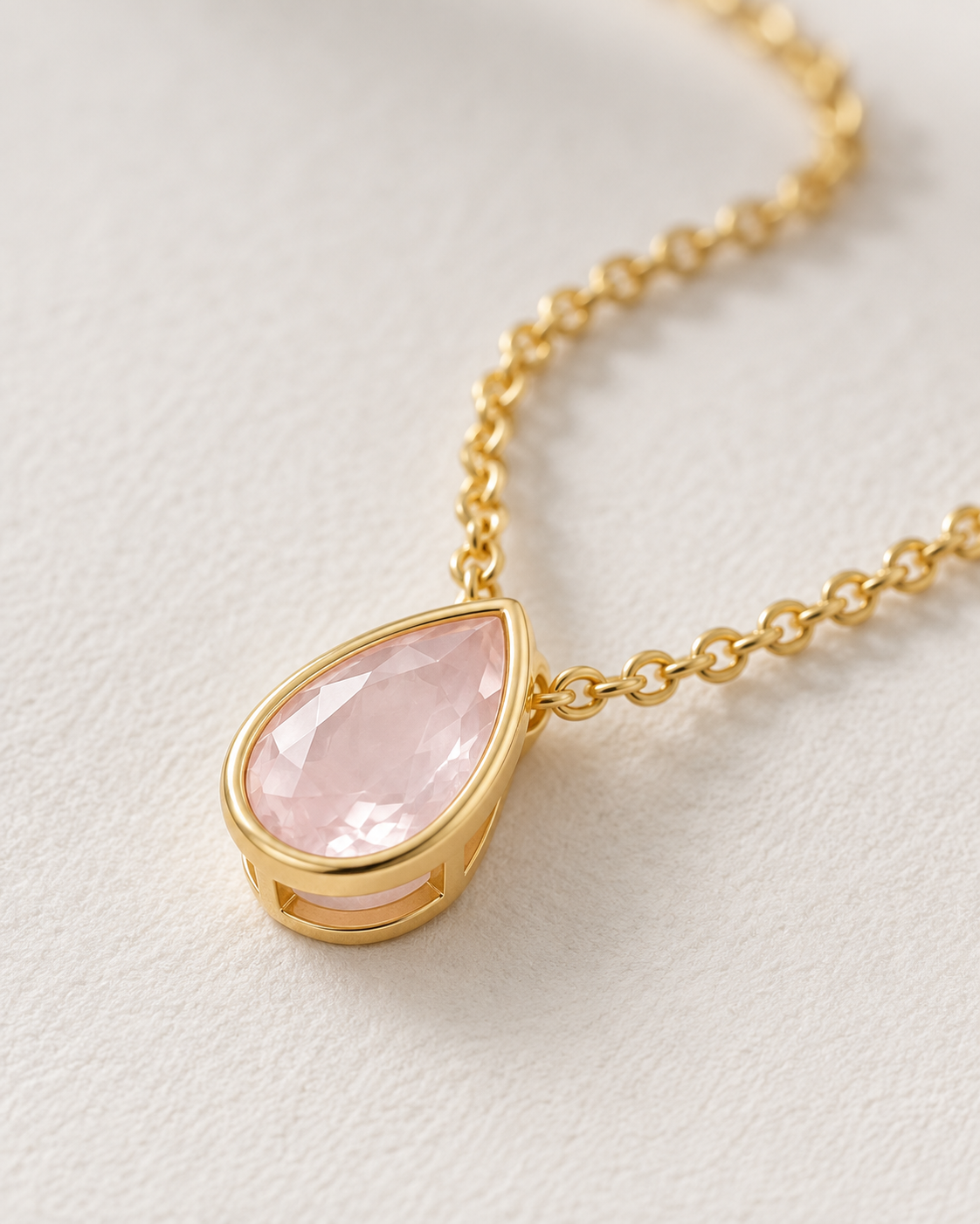 Close-up of Rose Quartz Pear Bezel Pendant, showing the gold finish over sterling silver