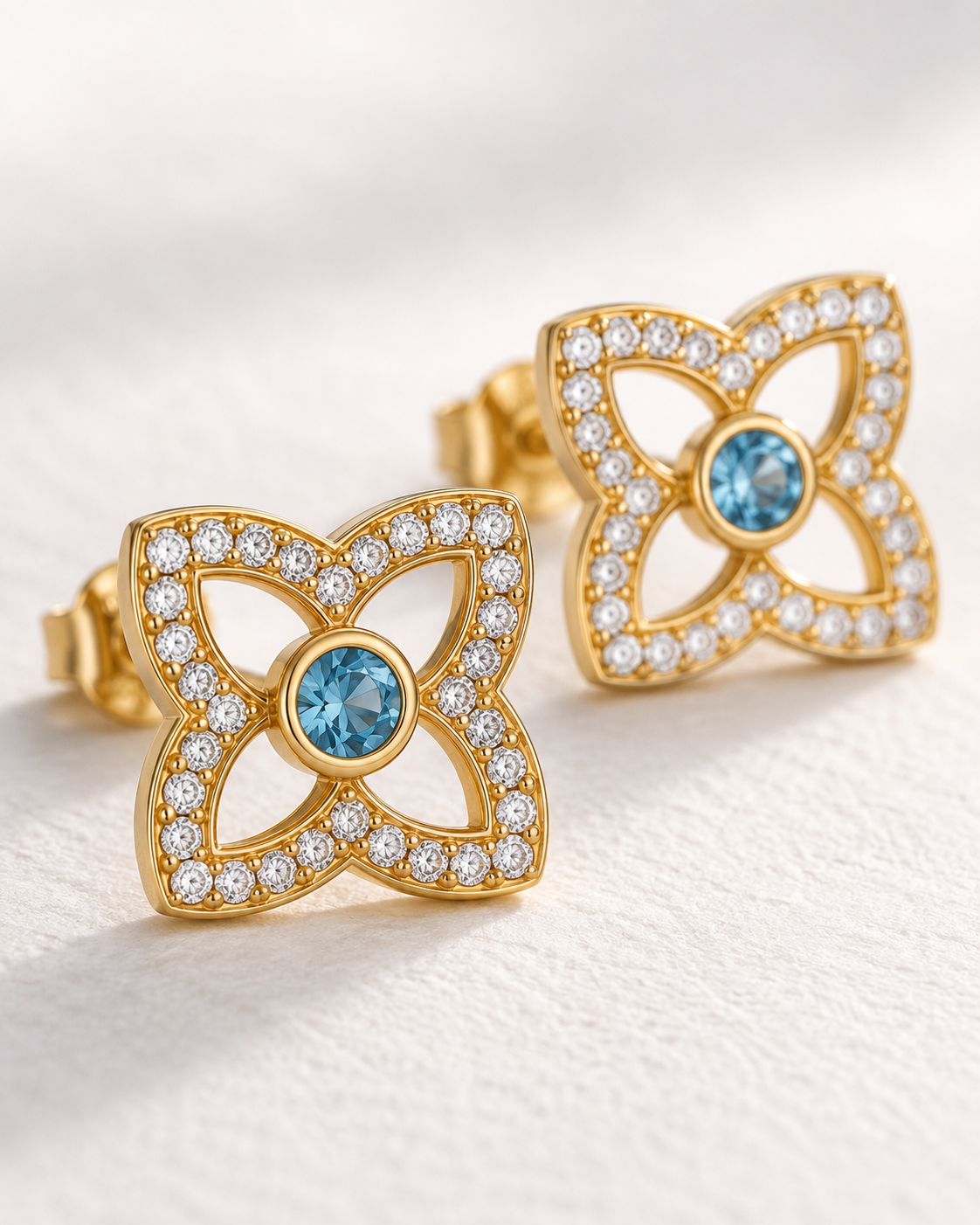 Close-up of Blue Topaz Clover Pave Studs, showing the gold finish over sterling silver